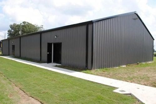 Large gray industrial storage building exterior.