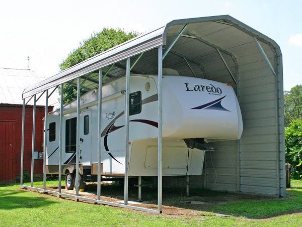 Camper stored in protective canopy