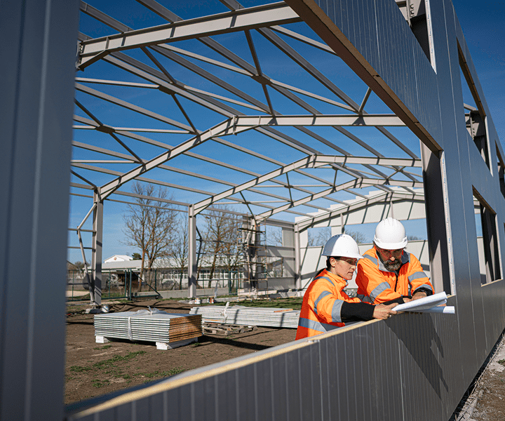 Building frame with construction team planning