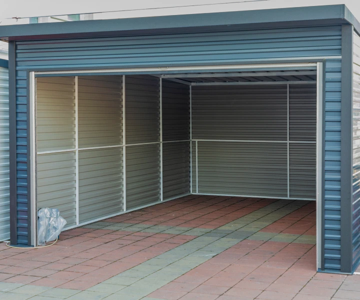 Empty steel garage on paved driveway