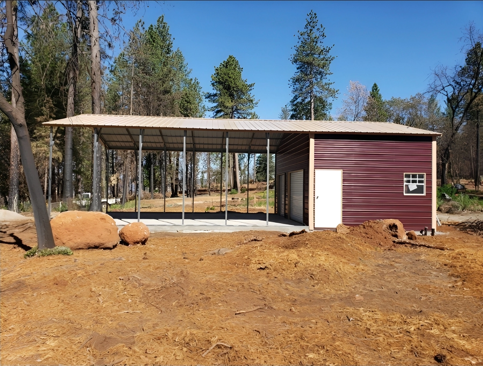 Open barn structure in a forest setting.