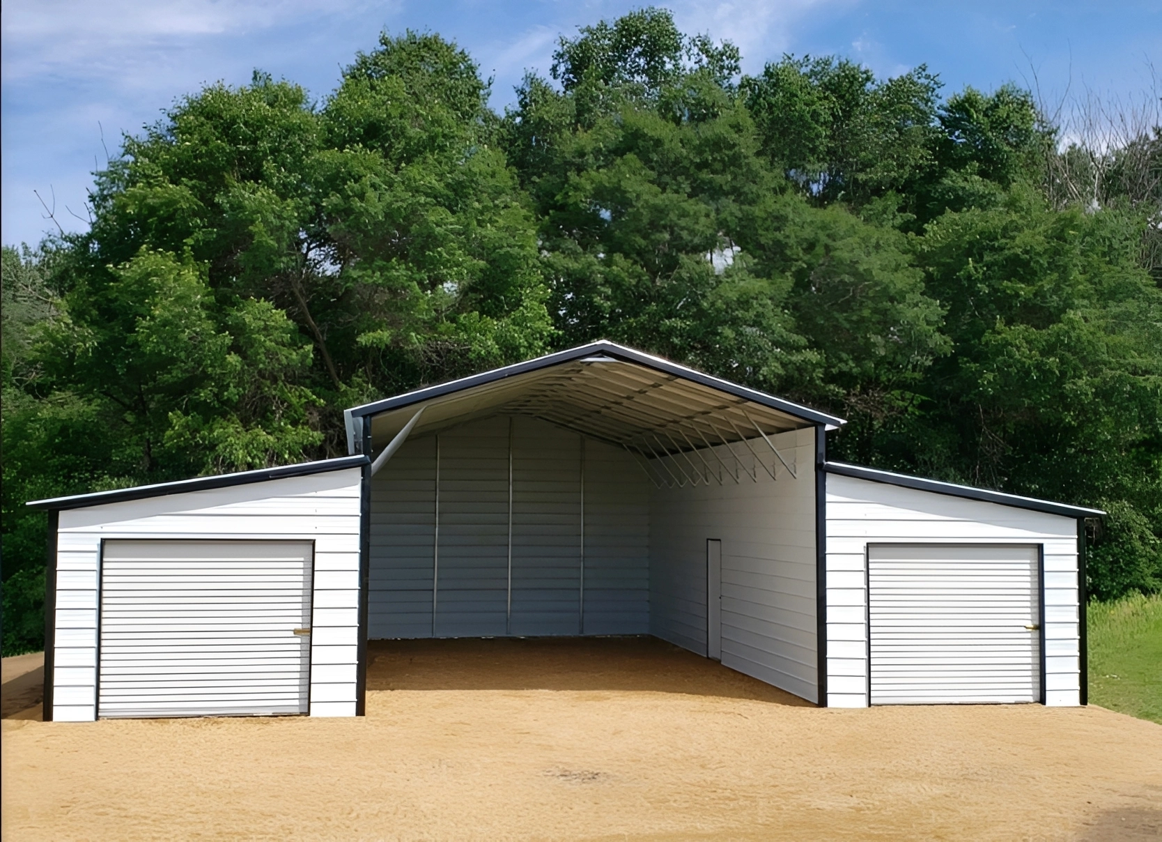 Large white shed surrounded by trees.