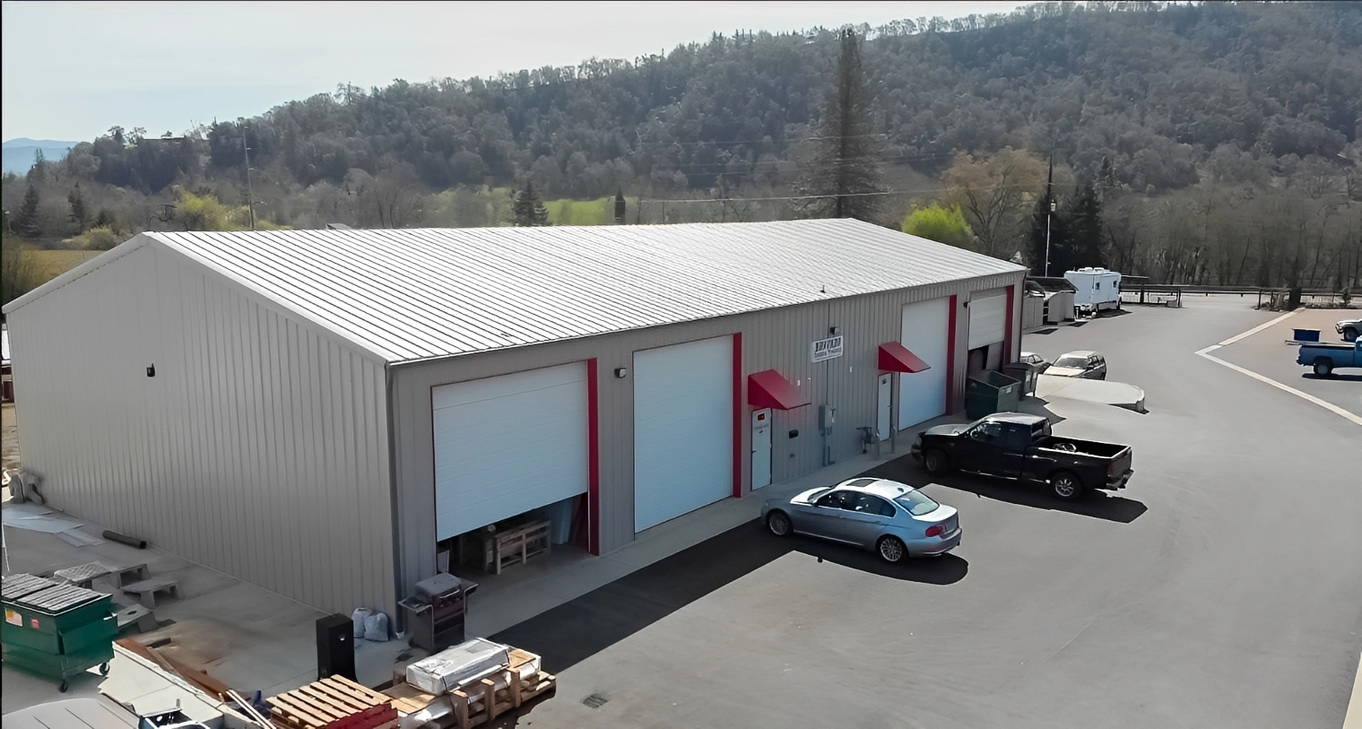 Warehouse surrounded by trees and hills