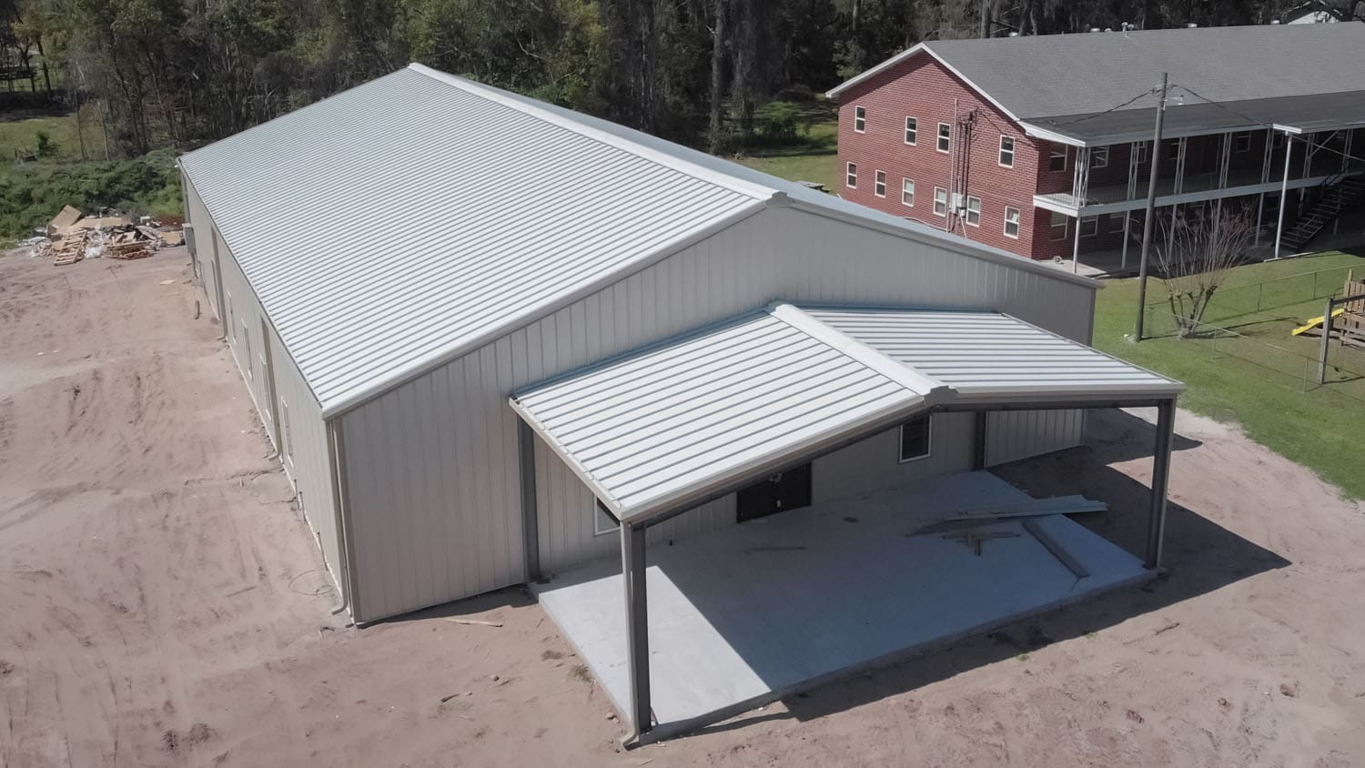 Large metal building with covered entrance area.