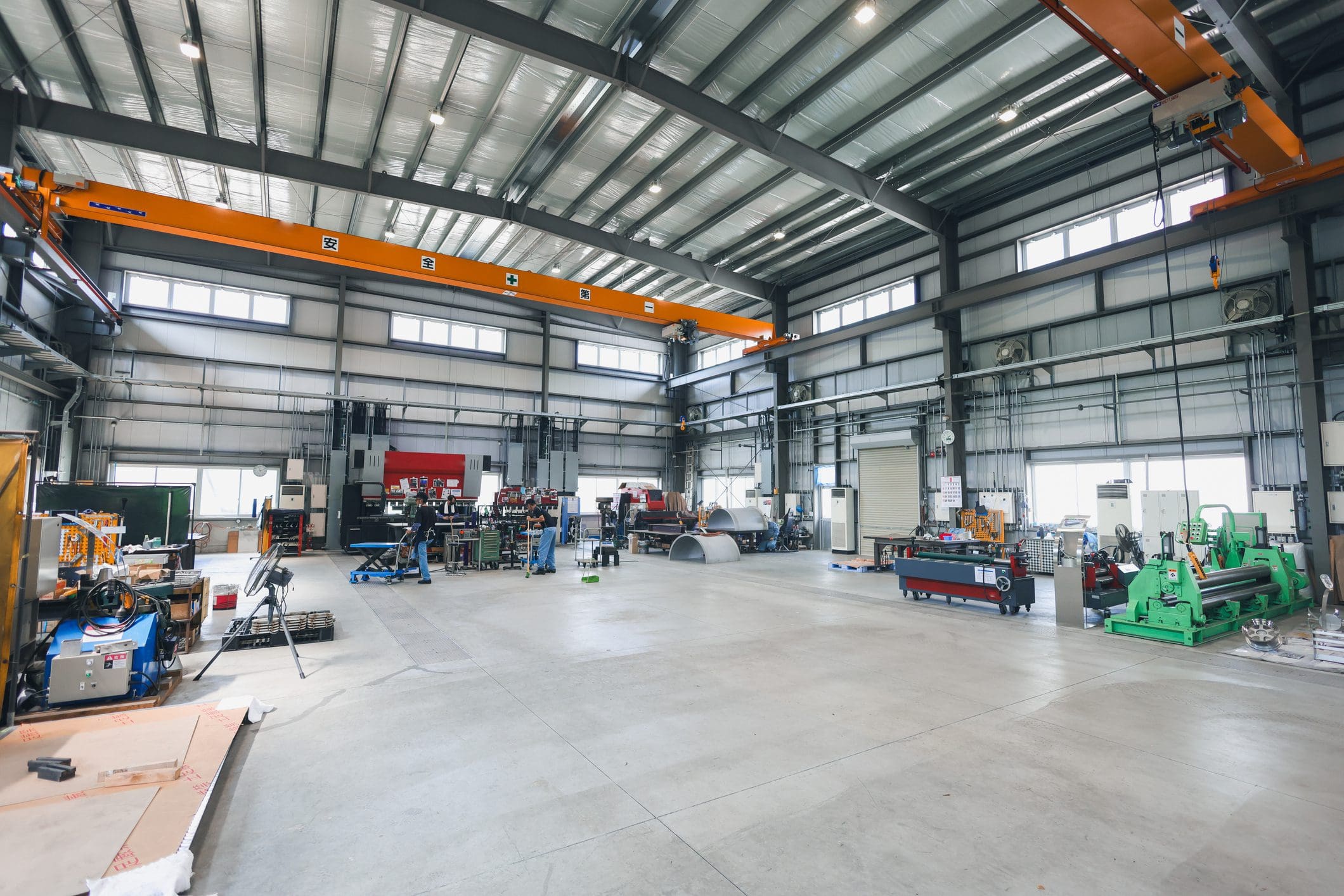 Spacious industrial warehouse with machinery and equipment.