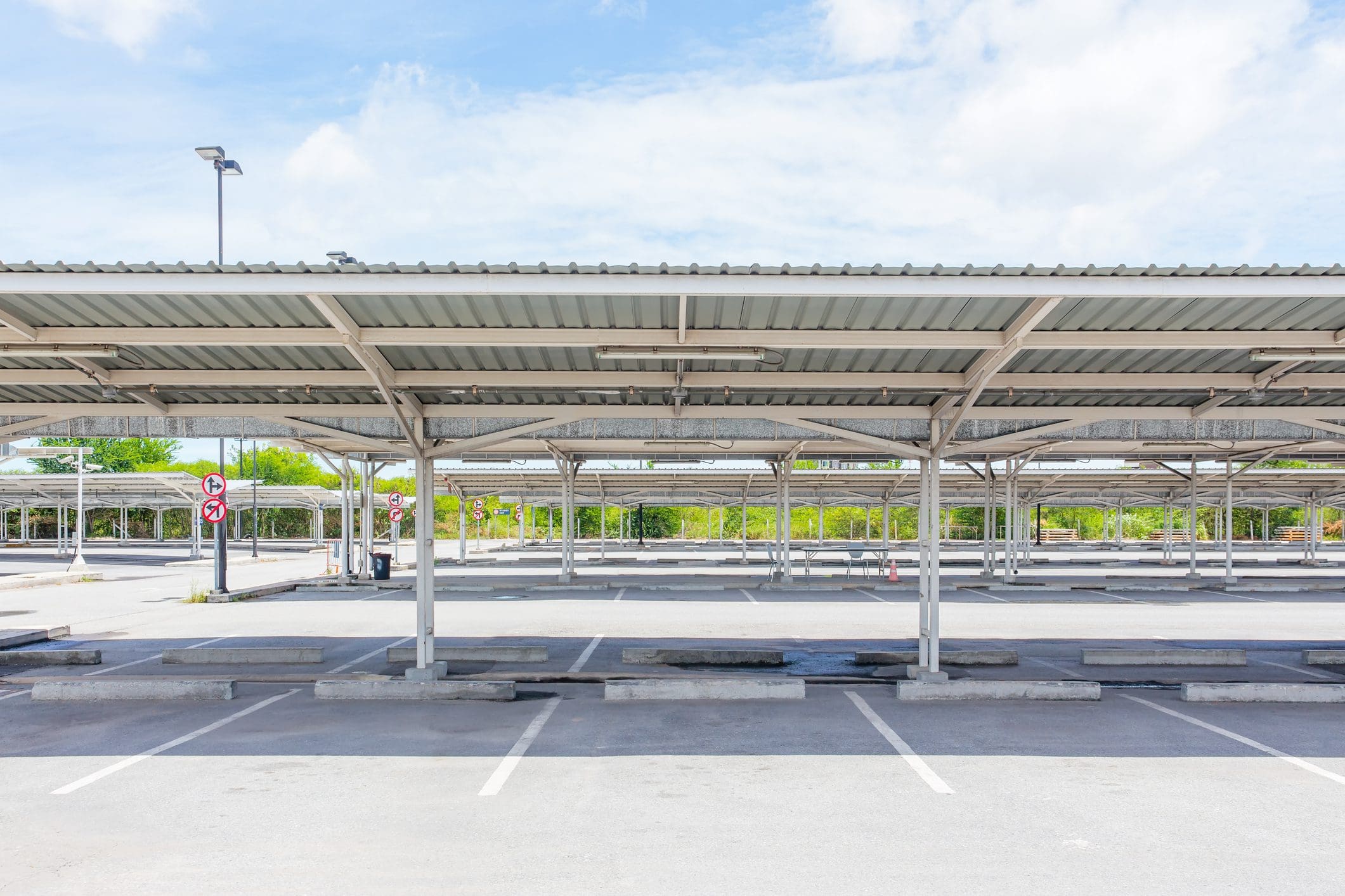 Empty covered parking lot on sunny day.