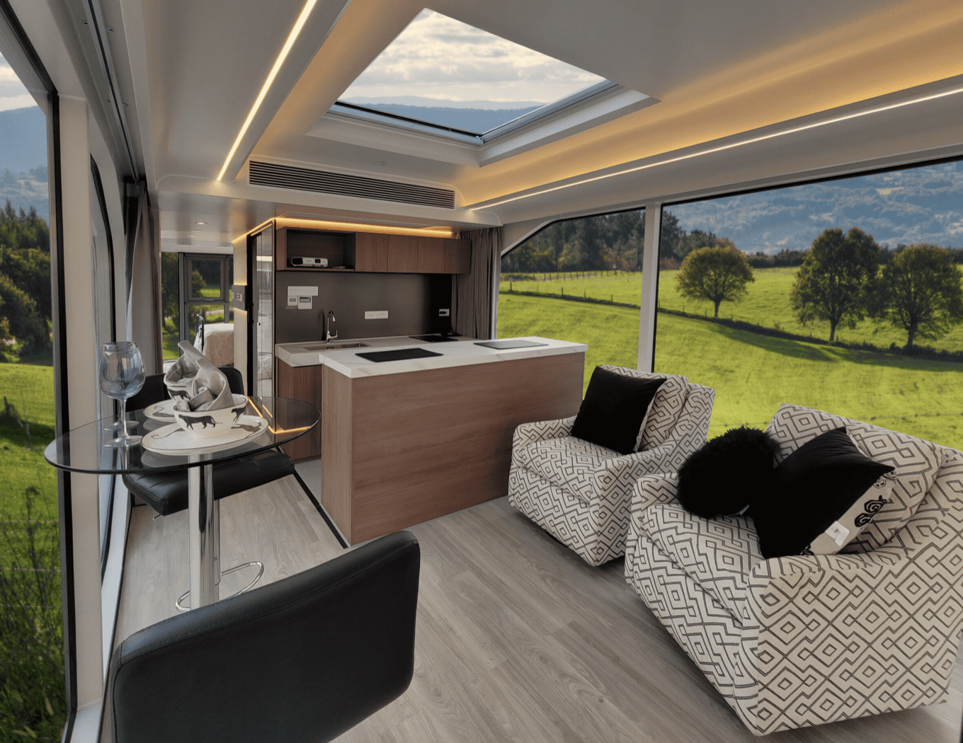 Luxury motorhome interior with scenic view.