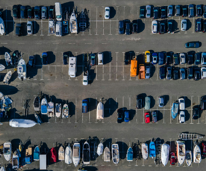 Aerial view of parked cars and boats.