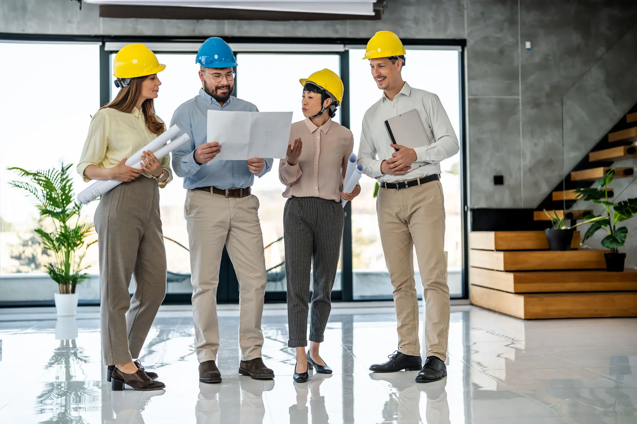 Architects discussing blueprints in modern building.