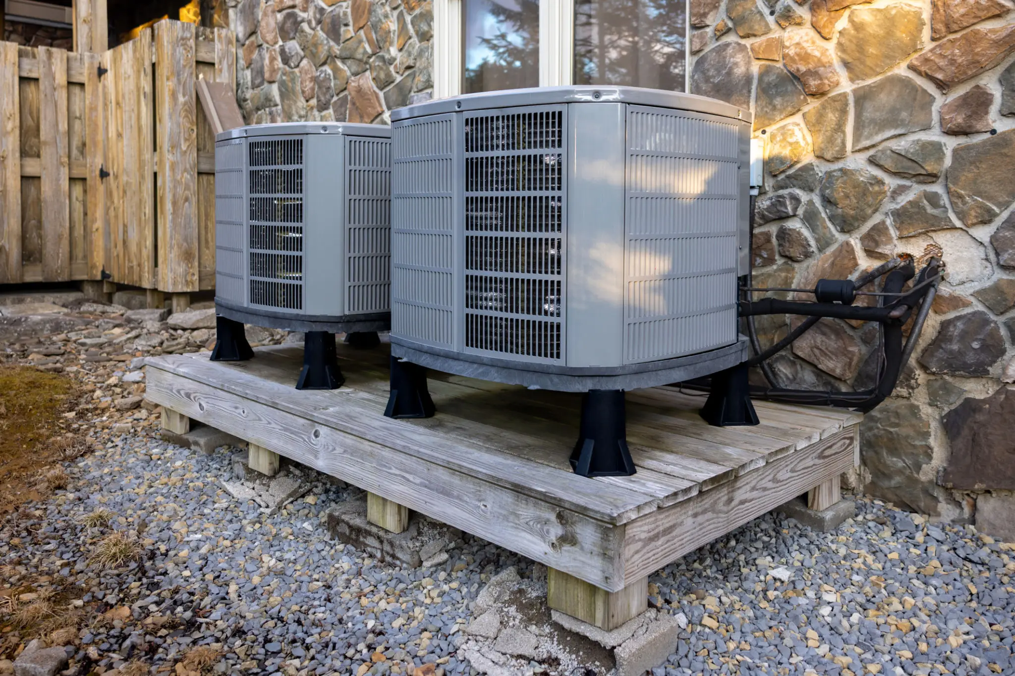 Two outdoor air conditioning units on platform.