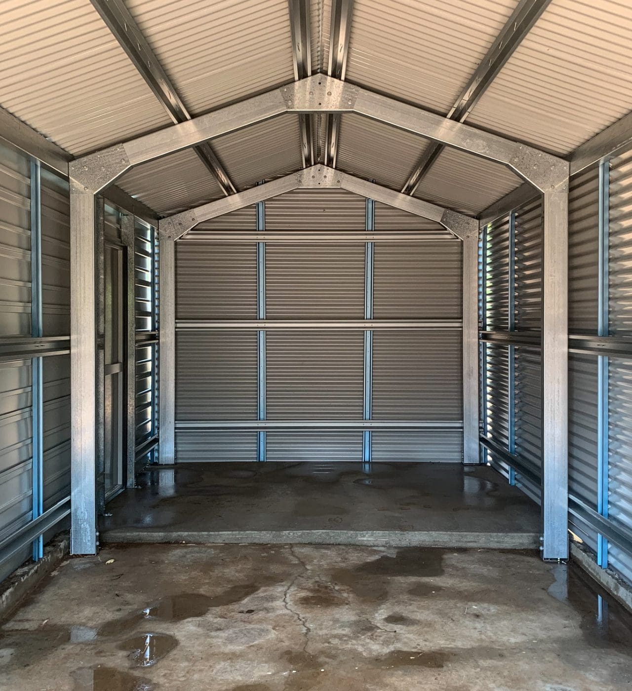 Interior view of empty metal storage shed.