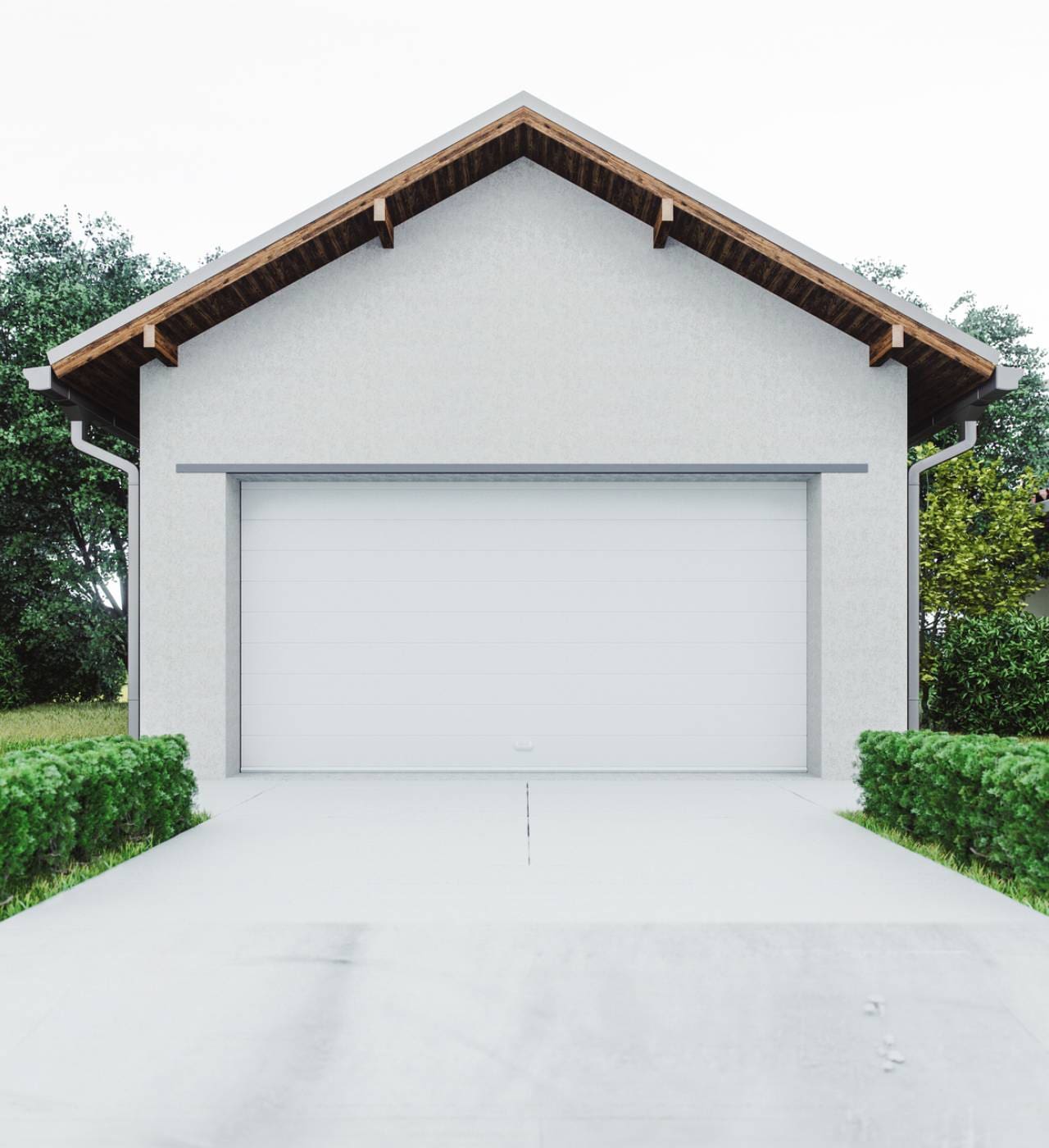 White garage with green shrubs and trees.