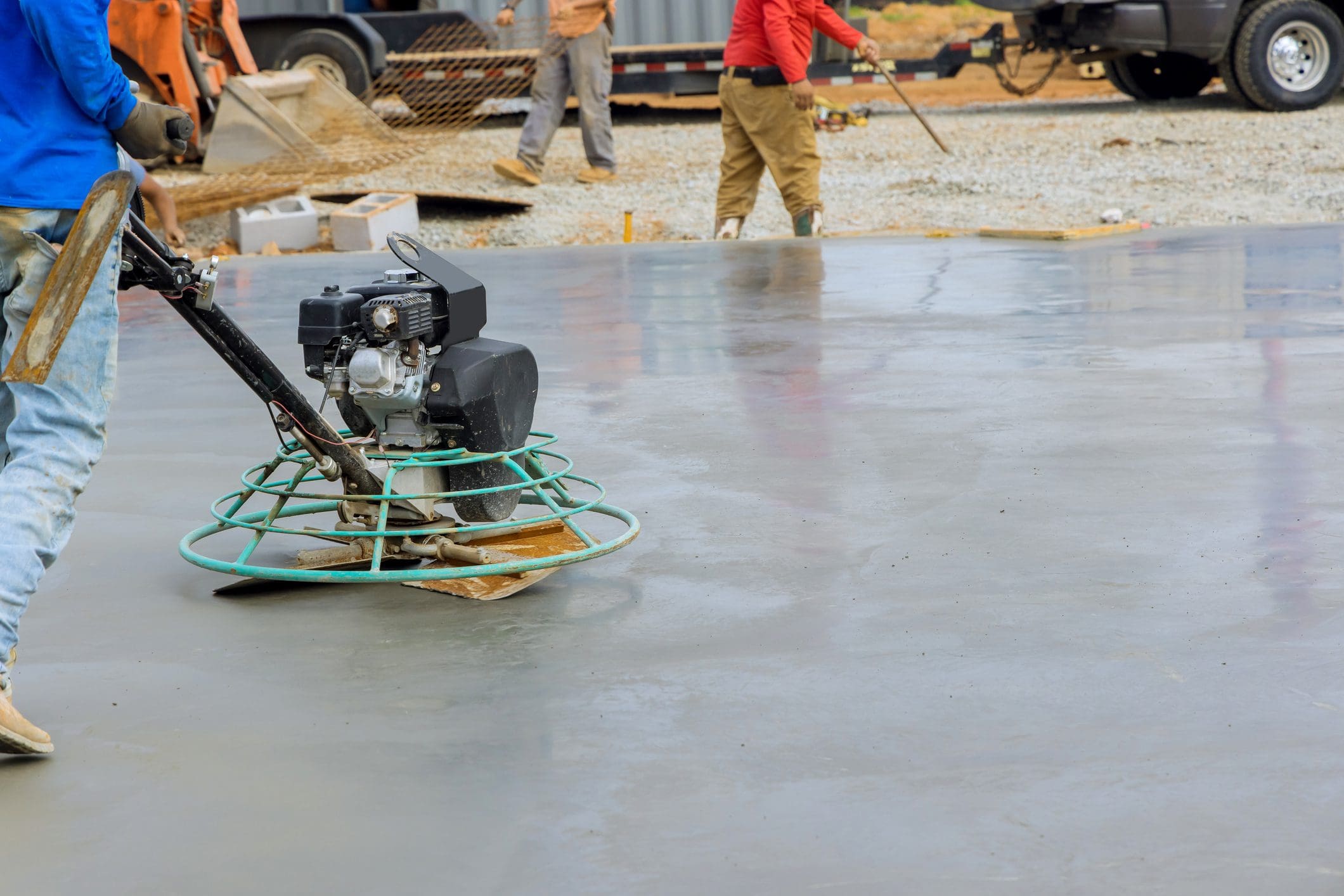 Concrete smoothing with power trowel machine.