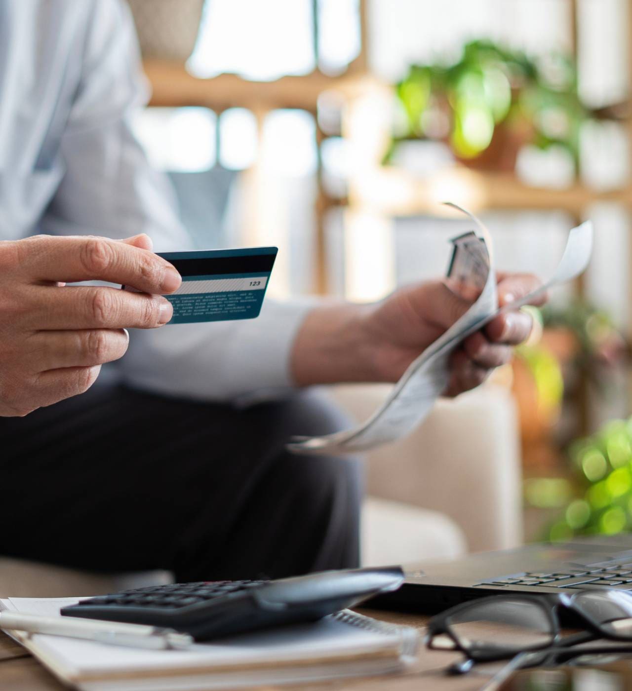 Person holding credit card and receipt.