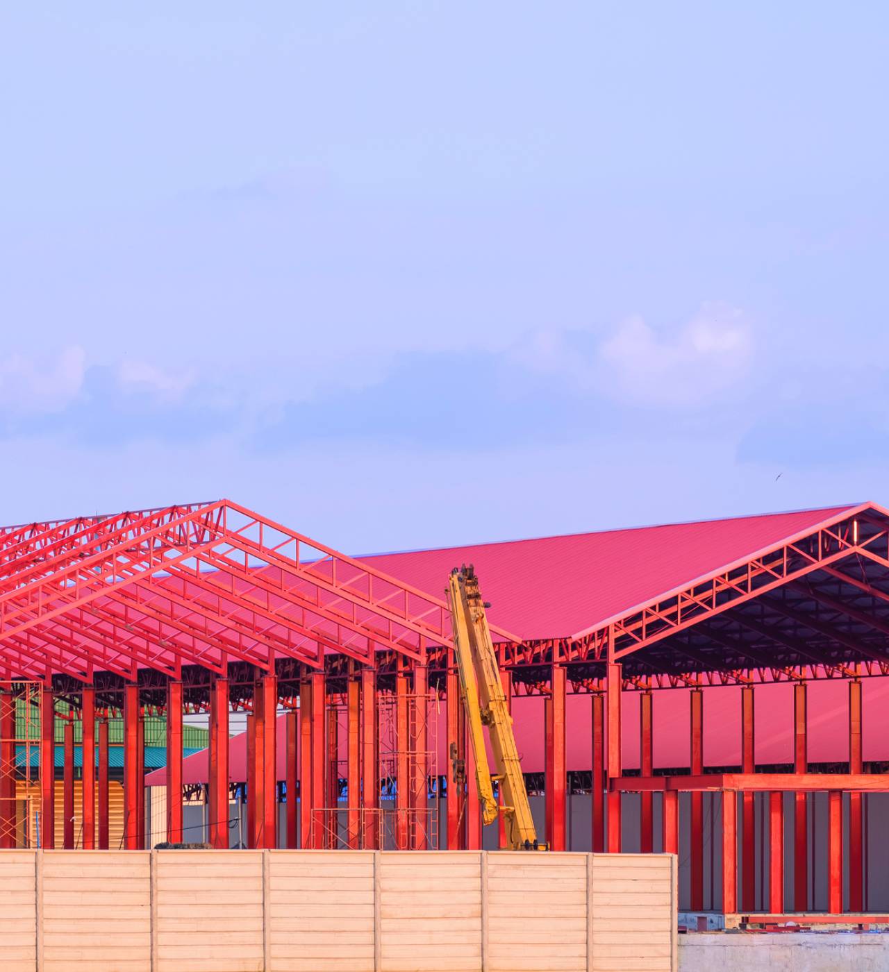 Red metal structure under blue sky.
