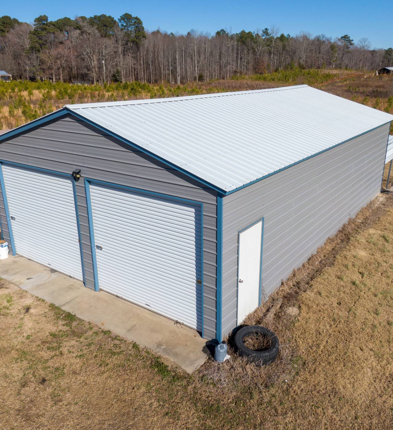 Gray metal garage in a rural area.