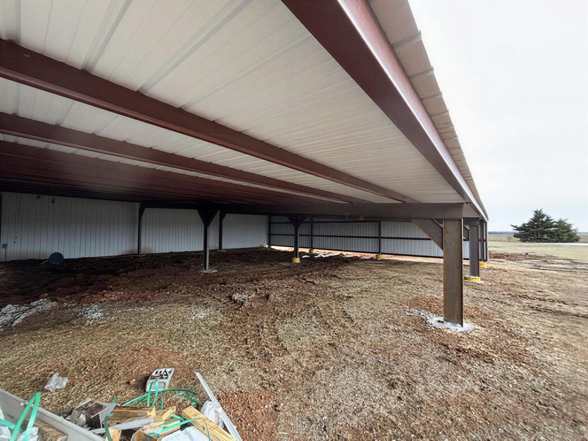 Open-sided metal structure with dirt floor.