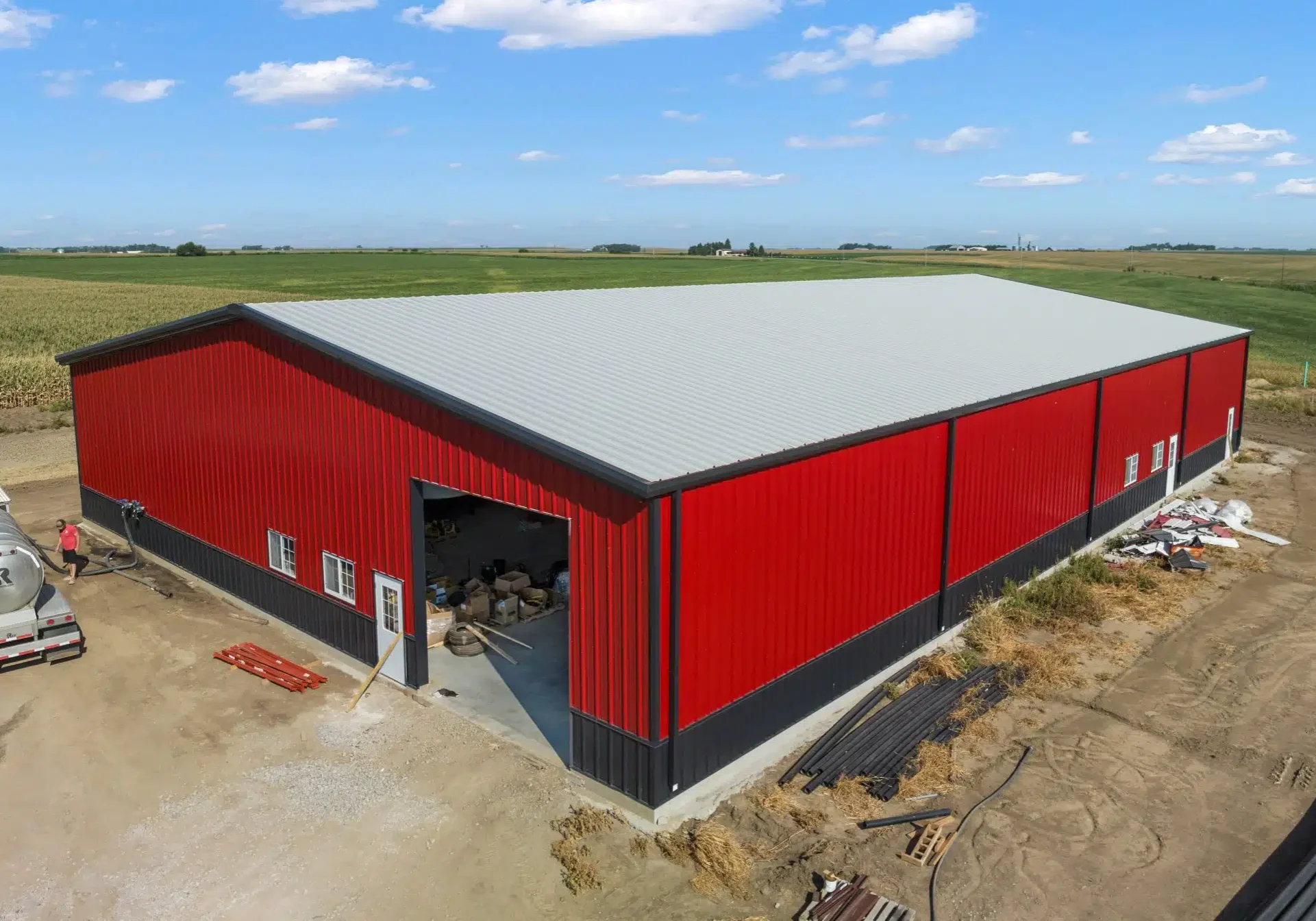 Red warehouse building in rural area.