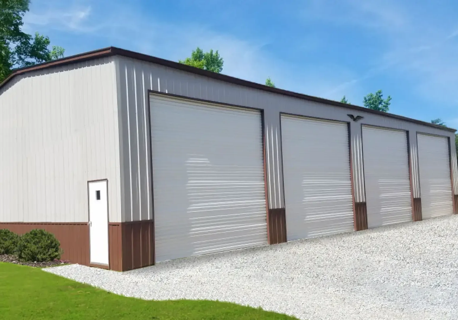 Large metal building with four garage doors.