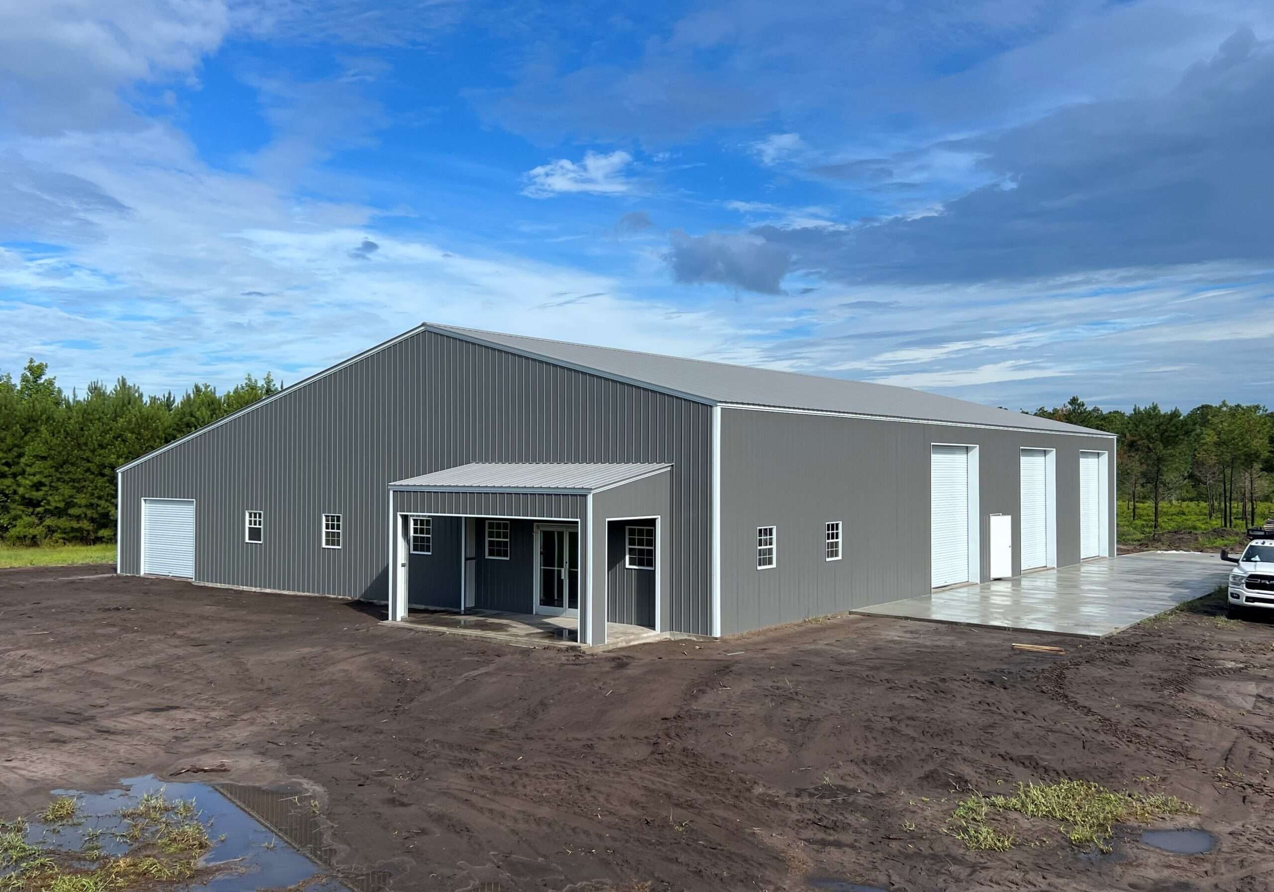 Large gray industrial building under blue sky.