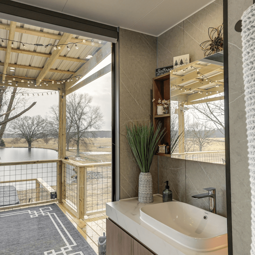 Bathroom with balcony overlooking a lake.