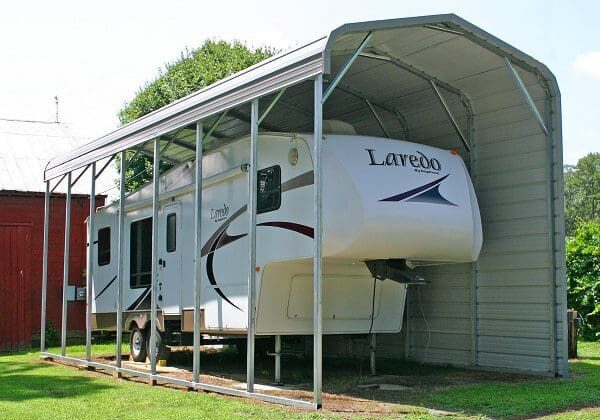 Camper stored in protective canopy